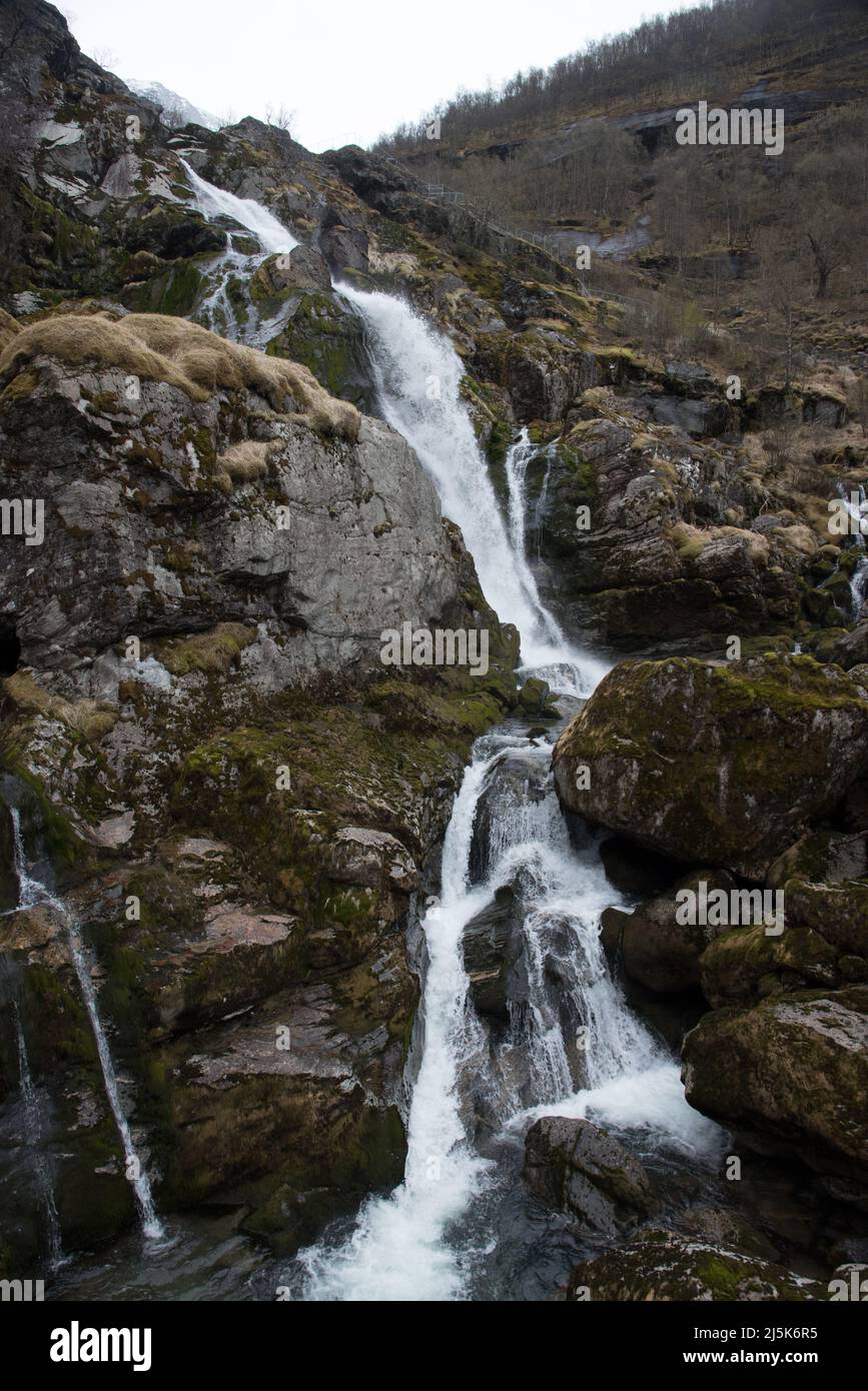 Fed bei meltwater in Norway's Vestland county in Briksdal valley an impressing river runs over thundering waterfalls towards Olden valley. Stock Photo