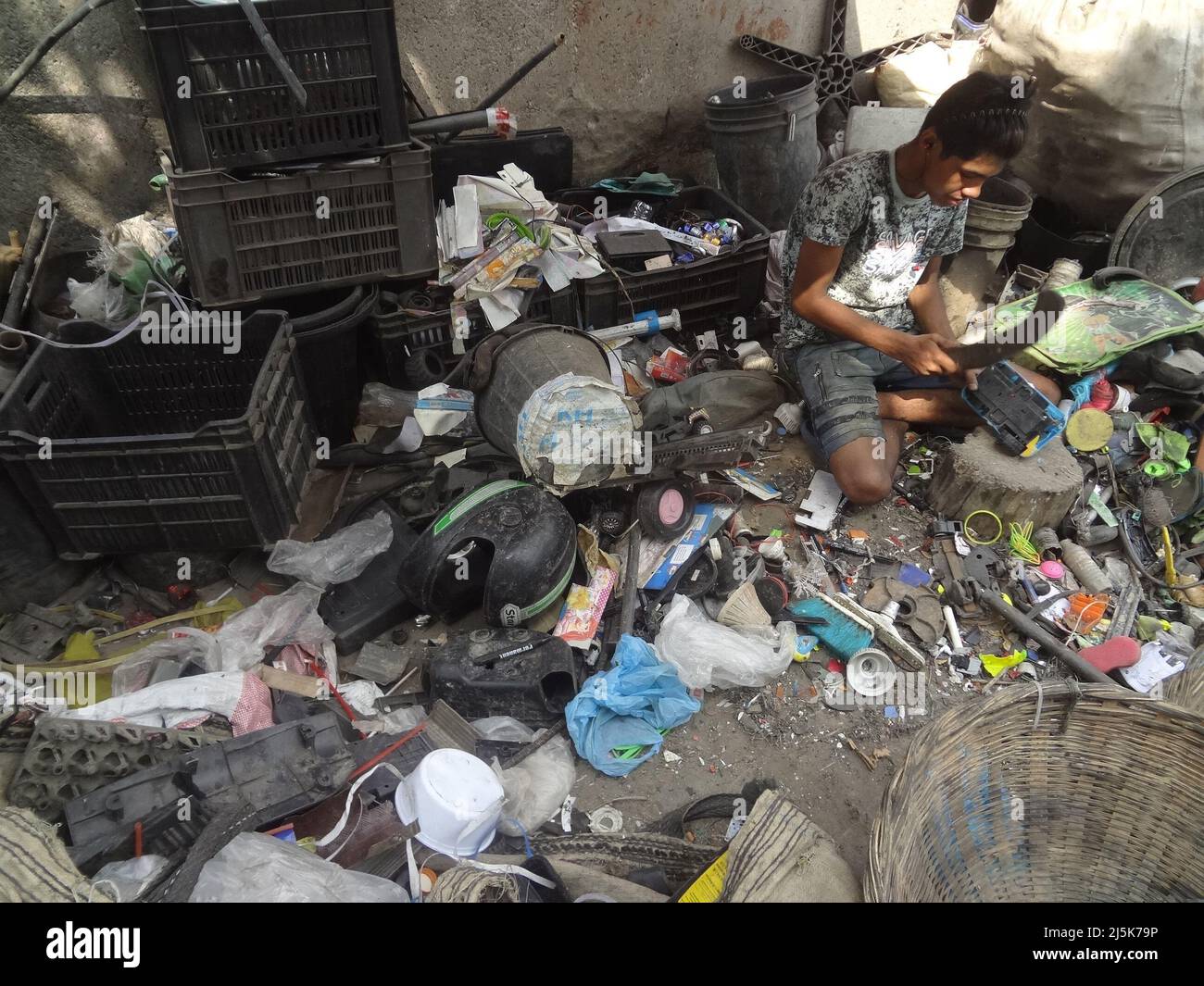 April 24, 2022, Dhaka, Bangladesh A worker separates different types