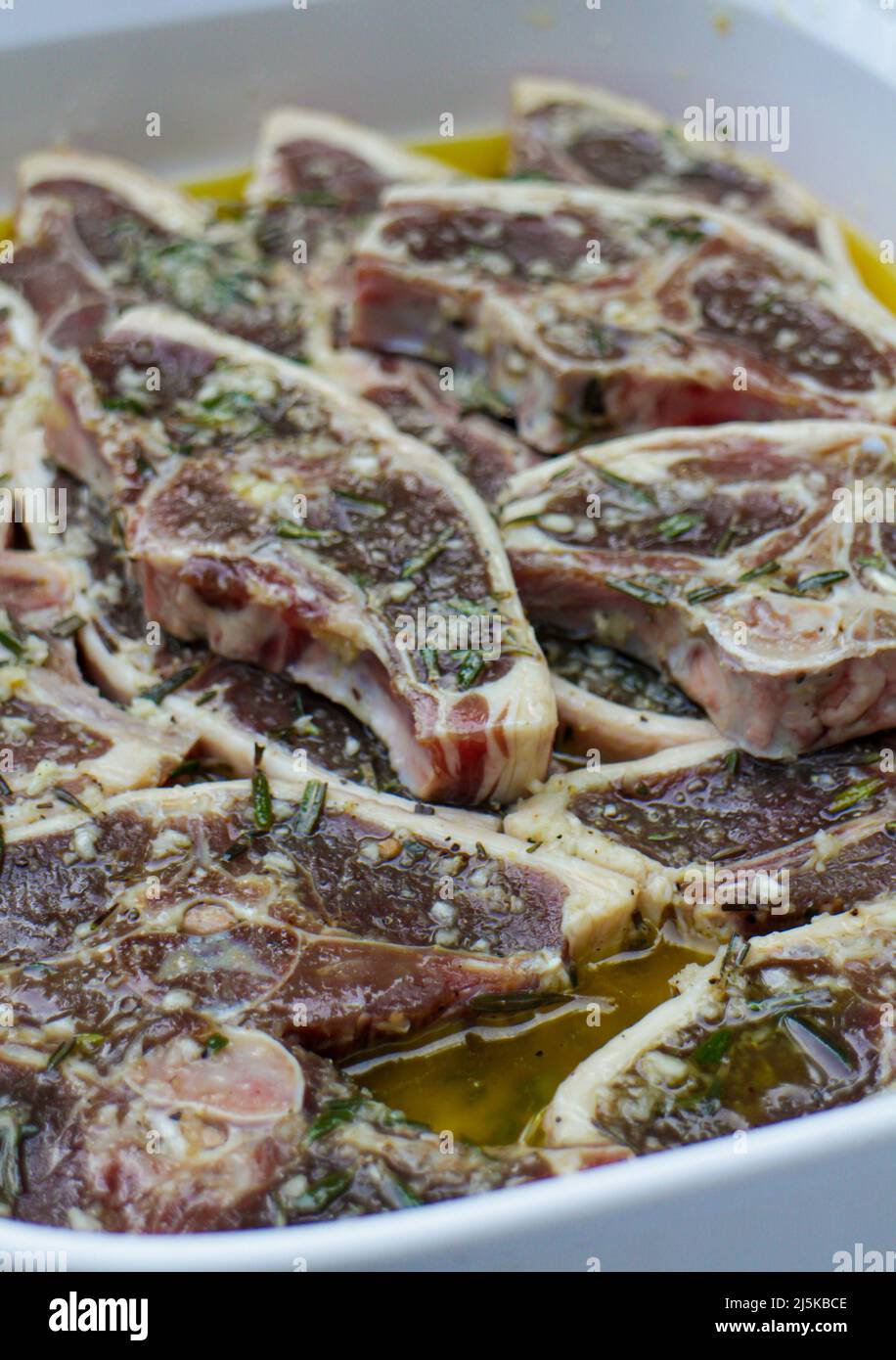 marinated lamb steaks prepared on a plate for a barbecue party in the