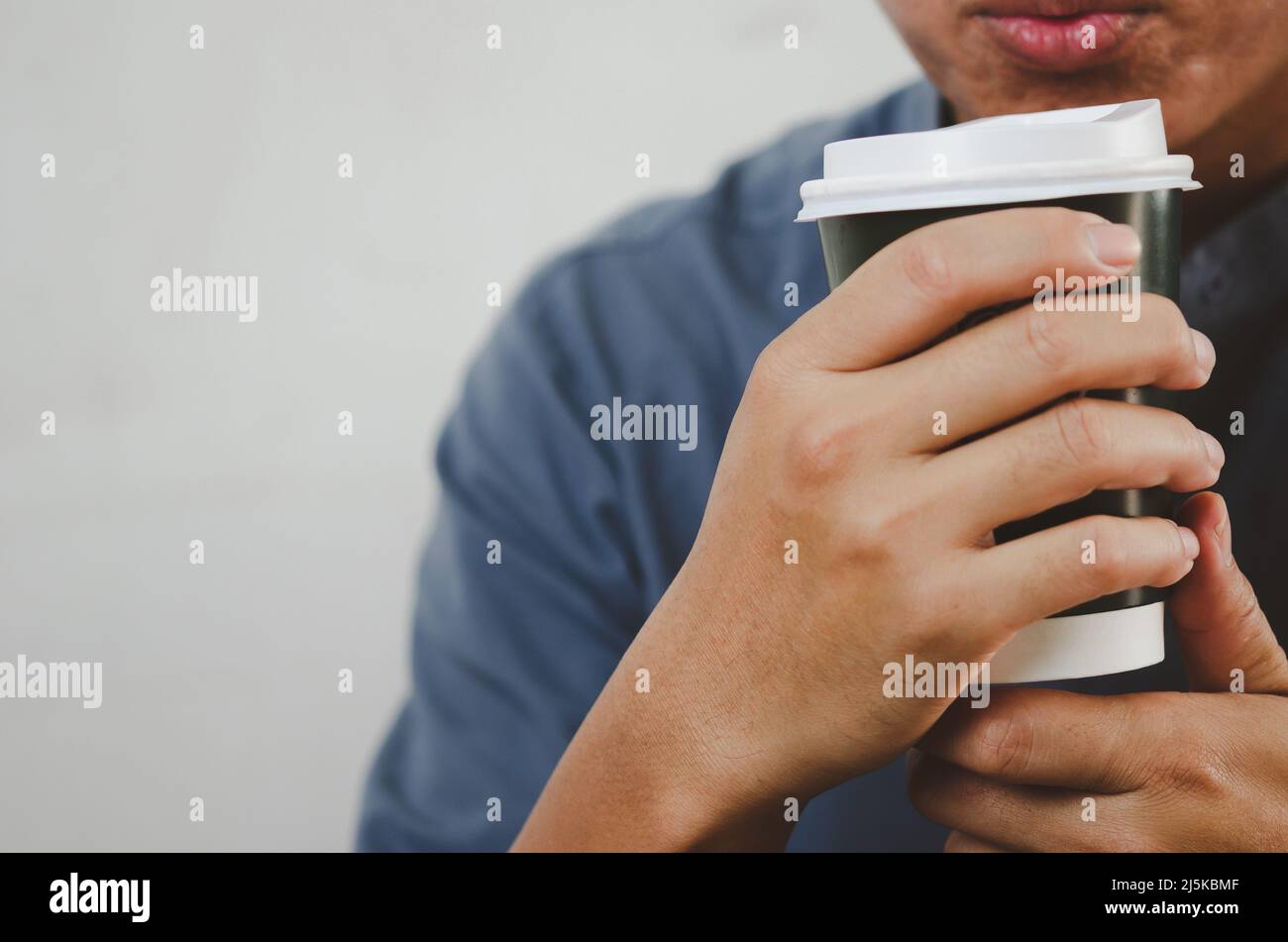 man drinking coffee paper cup copy space Stock Photo - Alamy