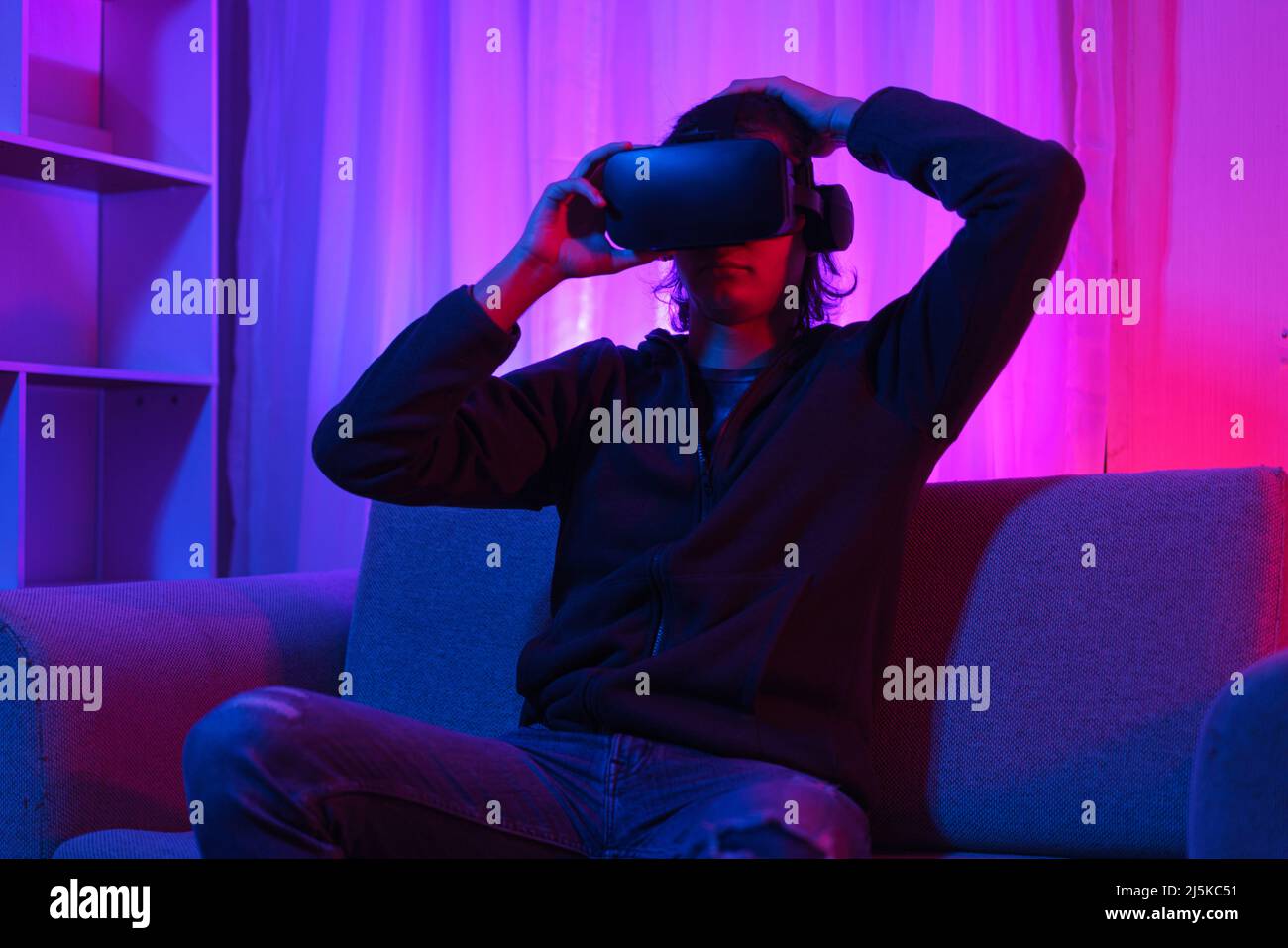 Metaverse technology concept, Man holding VR goggles and have fun