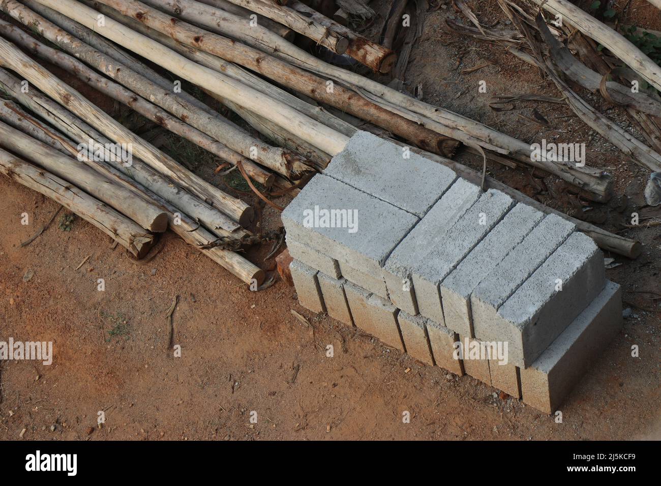 View from a small construction site where the pile of bricks and wooden ...