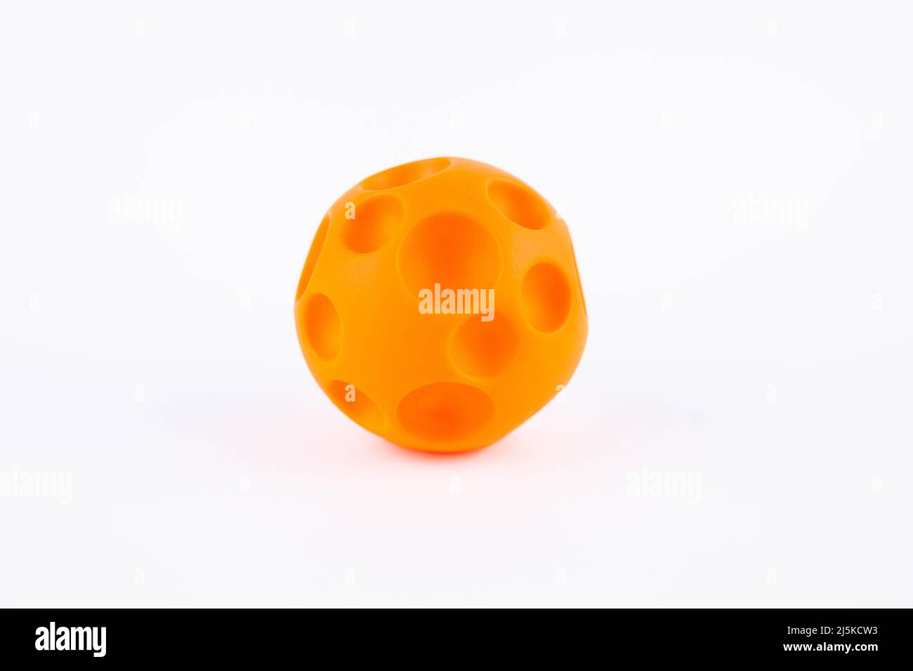 orange rubber ball for dog child toy on white background Stock Photo Alamy