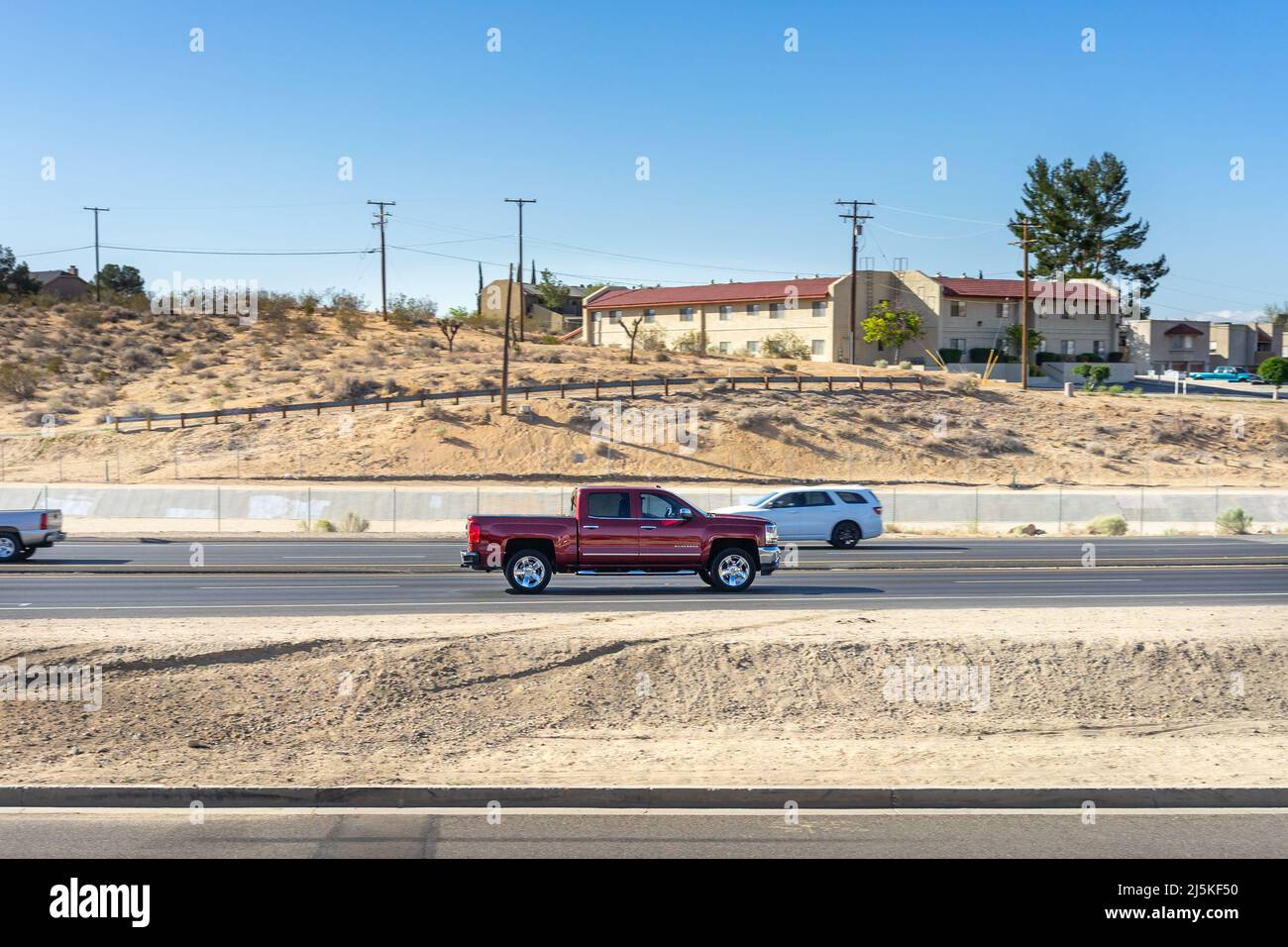 Apple Valley, CA, USA – April 20, 2022: A Chevy Silverado pickup truck traveling on Highway 18 in Apple Valley, California. Stock Photo
