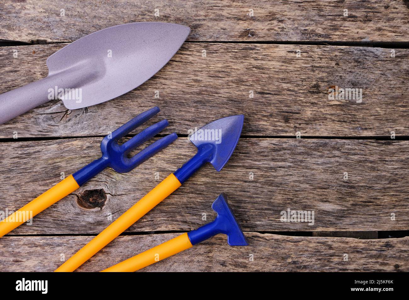 Decorative rake, pitchfork and shovel, garden tool wooden background ...