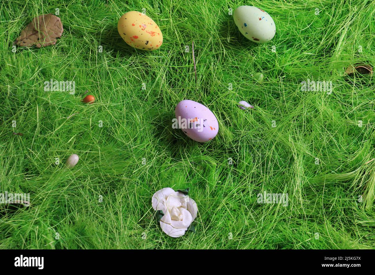 Pastel colored Easter chocolate eggs on green grass. Stock Photo