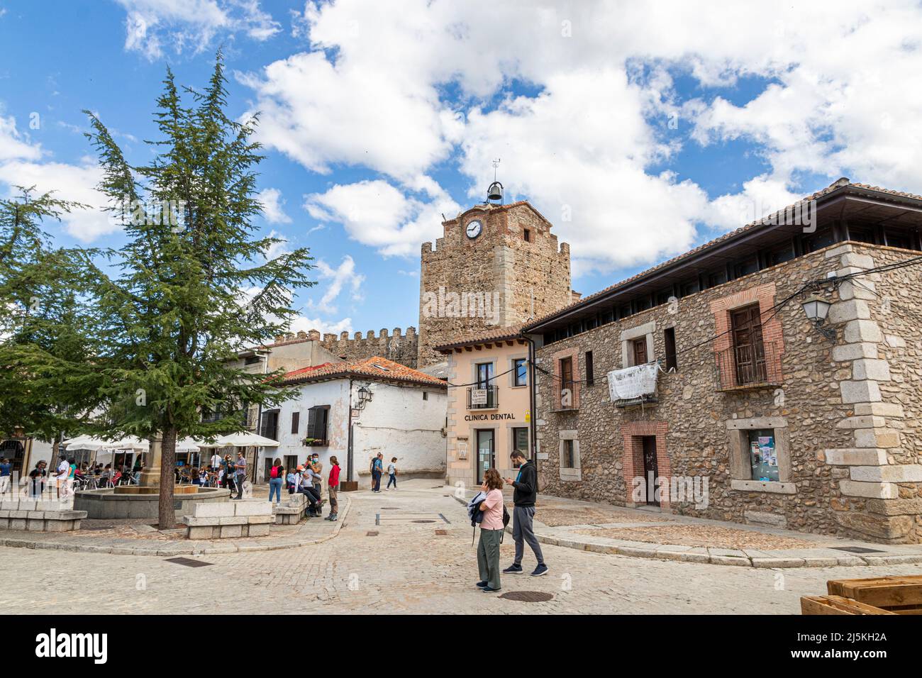 Buitrago del Lozoya, Spain. The Torre Albarrana, a city gate and defensive clock tower of the walled Old Town, seen from Plaza de la Constitucion Stock Photo