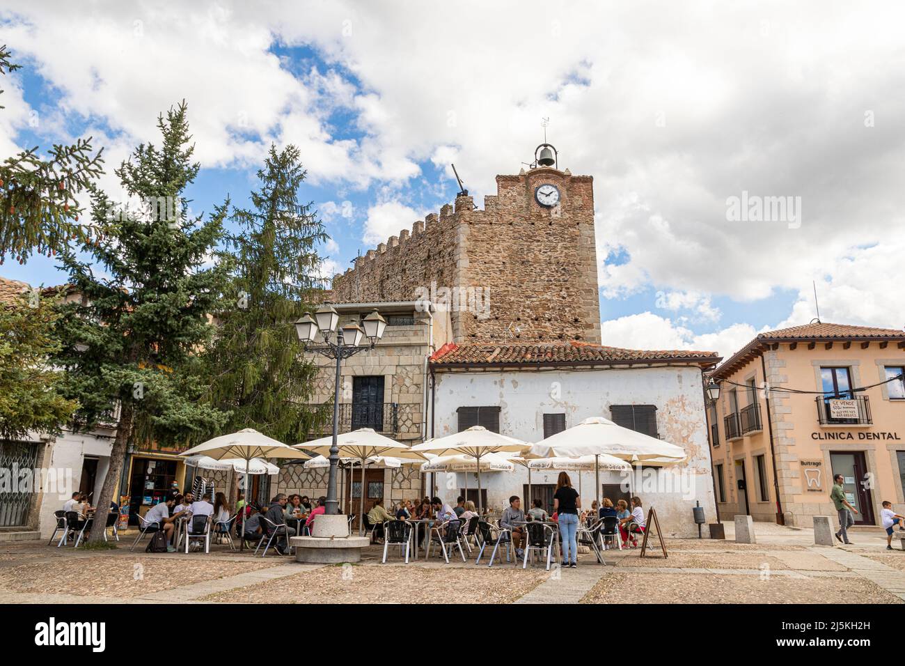 Buitrago del Lozoya, Spain. The Torre Albarrana, a city gate and defensive clock tower of the walled Old Town, seen from Plaza de la Constitucion Stock Photo