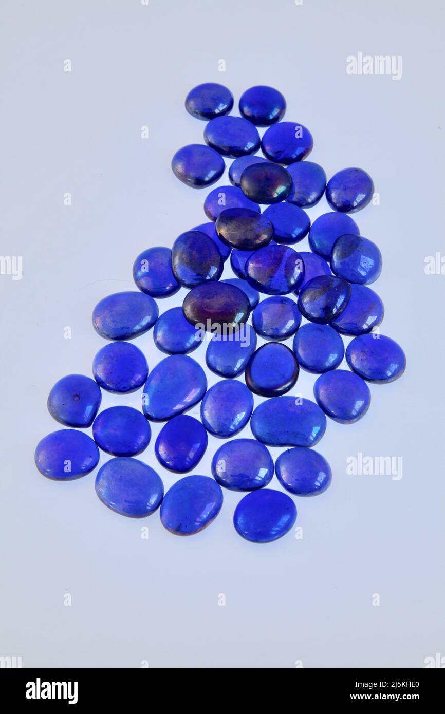 Blue glass bead patterns on white background April 2022 Stock Photo