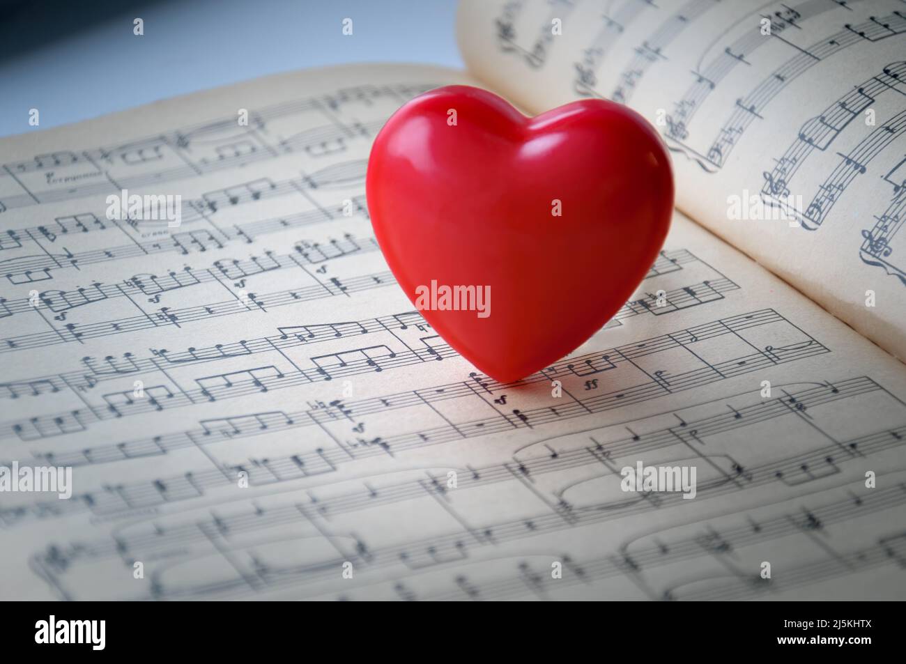 Red heart on a background of notes. The red heart is on the notes. Stock Photo