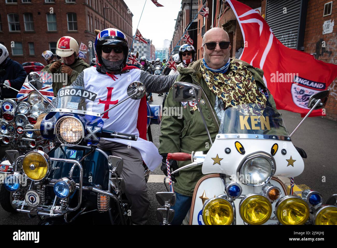 Manchester, UK. 24th Apr, 2022. Two Mod Scooters riders join the the annual St Georges Day parade as it passes through the city. Hundreds of people join in the annual celebration which marks the death of the patron Saint Of England.ÊAndy Barton/Alamy Live News Credit: Andy Barton/Alamy Live News Stock Photo