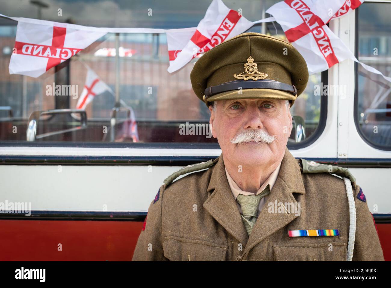 Manchester, UK. 24th Apr, 2022. A veteran awaits the start of the annual St Georges Day celebration which marks the death of the patron Saint Of England. Credit: Andy Barton/Alamy Live News Stock Photo