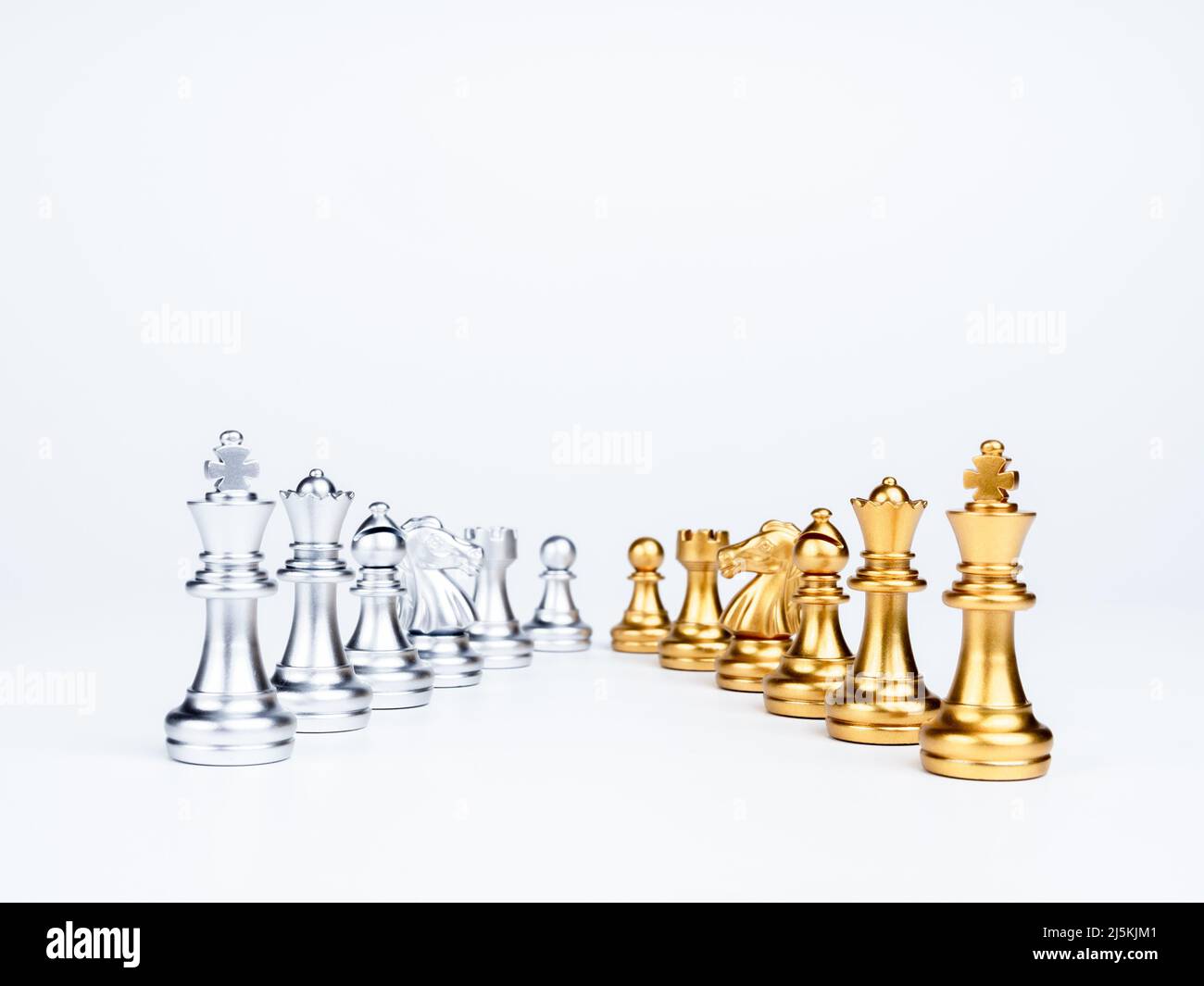 Set of luxury golden and silver chess pieces isolated on white background. The photo of rows of silver and gold chess, king, rook, bishop, queen, knig Stock Photo