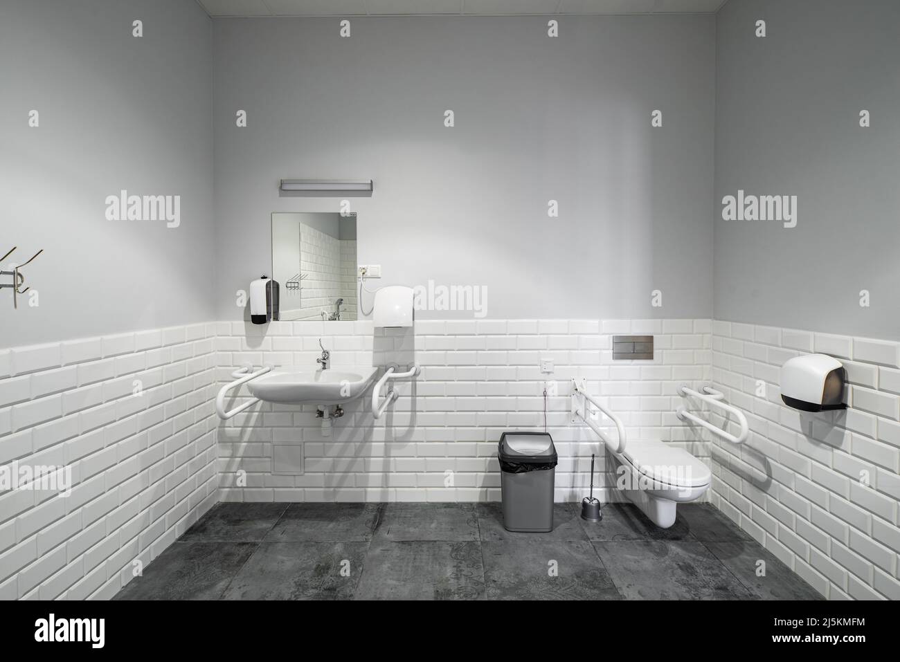 The interior of bathroom with facilities for the disabled. White bricks