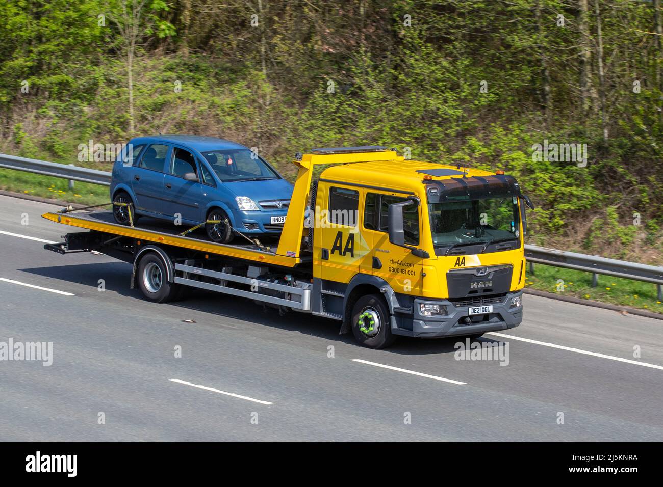 AA Roadside 24hr breakdown recovery;  car transporter Man TGX (My2018) delivery trucks, carrying vehicle, delivery, commercial transport industry on the M61 in Manchester UK Stock Photo