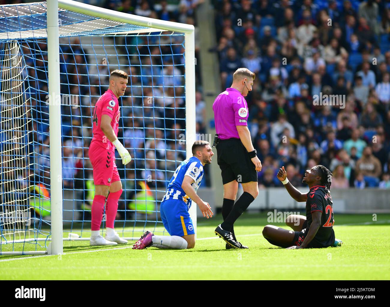 Brighton, UK. 24th Apr, 2022. Mohammed Salisu of Southampton and Neal Maupay of Brighton and Hove Albion clash in the box watched on by Fraser Forster Goalkeeper of Southampton during the Premier League match between Brighton & Hove Albion and Southampton at The Amex on April 24th 2022 in Brighton, England. (Photo by Jeff Mood/phcimages.com) Credit: PHC Images/Alamy Live News Stock Photo