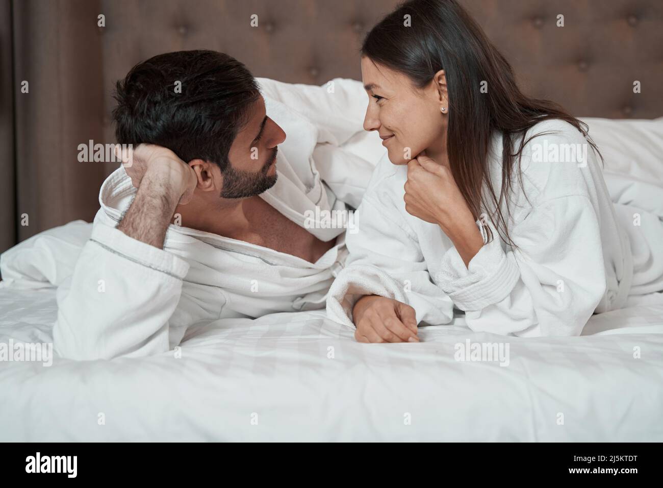 People in love talking while lying in bed Stock Photo - Alamy