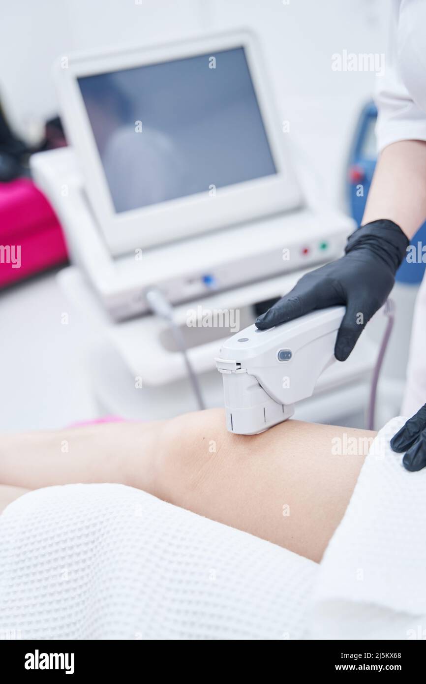 Woman having ultrasound lifting procedure in cosmetology clinic Stock ...