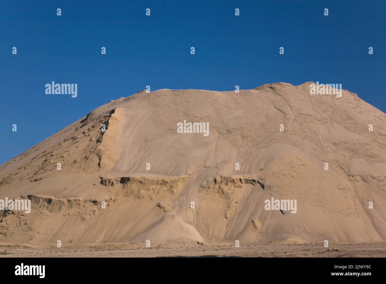 Mound of fine sand in a commercial sandpit. Stock Photo