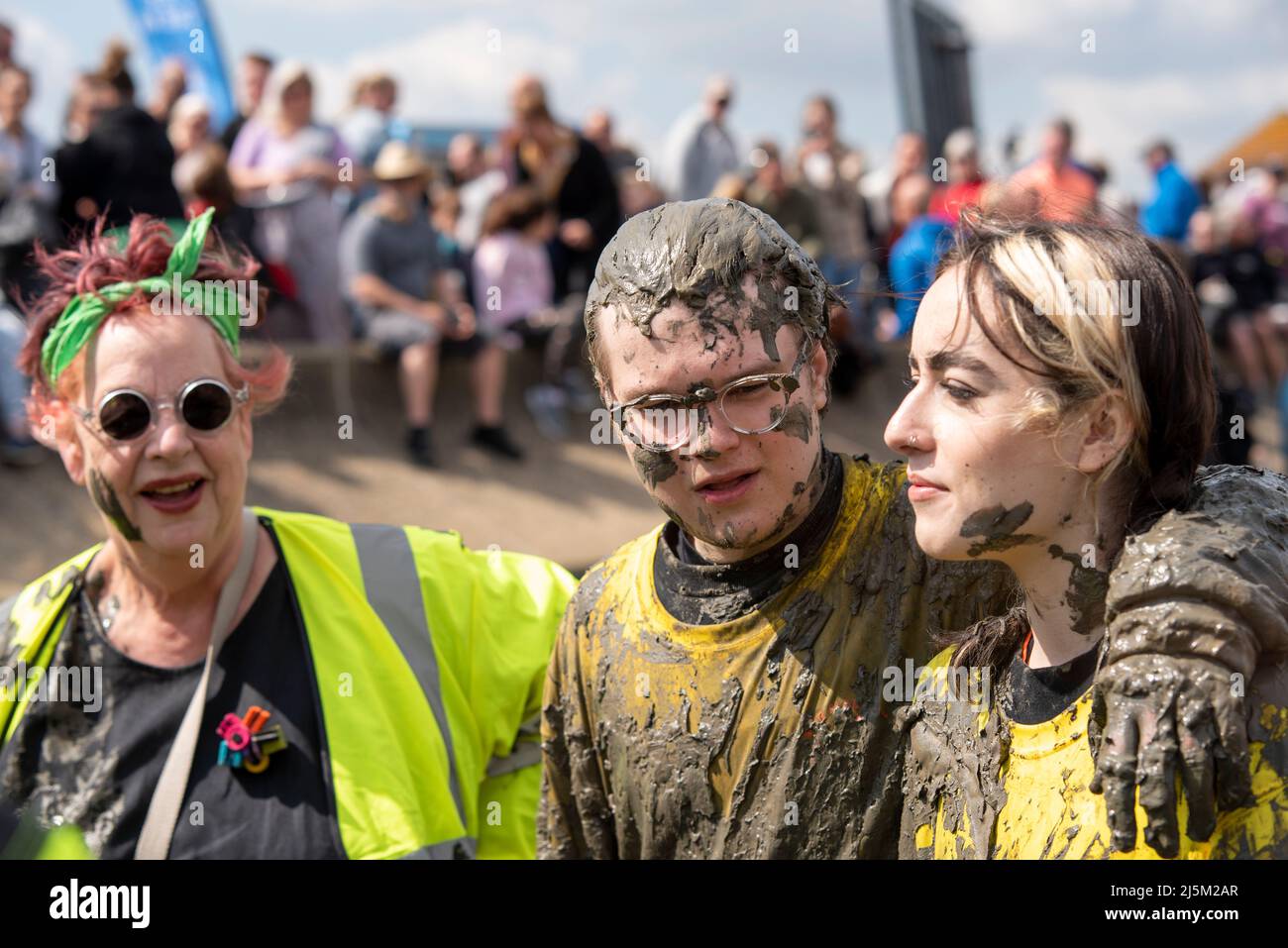 Maldon Promenade Park, Maldon, Essex, UK. 24th Apr, 2022. Maisi Bourke, daughter of Jo Brand and musician and social media star, took part in the Maldon Mud Race alongside her boyfriend Alfie to raise funds for Macmillan Cancer Support. Writing online before the event Maisi wrote: 'We've chosen to support Macmillan Cancer Support in memory of Sean Lock and my Uncle Bill, who were both lost to cancer last year.” Jo Brand welcomed the pair at the finish line, with her daughter wiping mud on Jo’s face Stock Photo