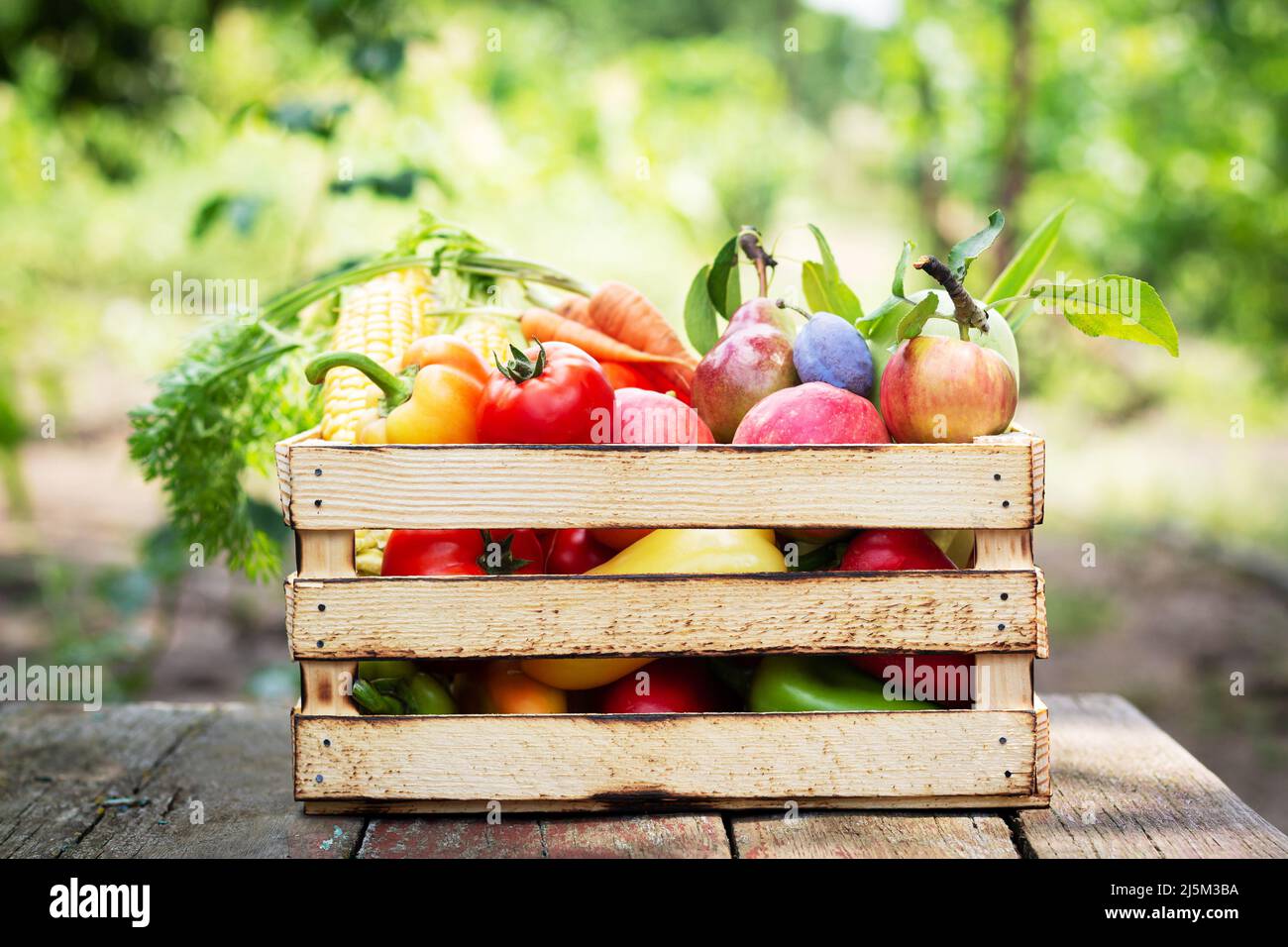Fresh organic vegetables and fruit in wooden crate. Healthy food on ...
