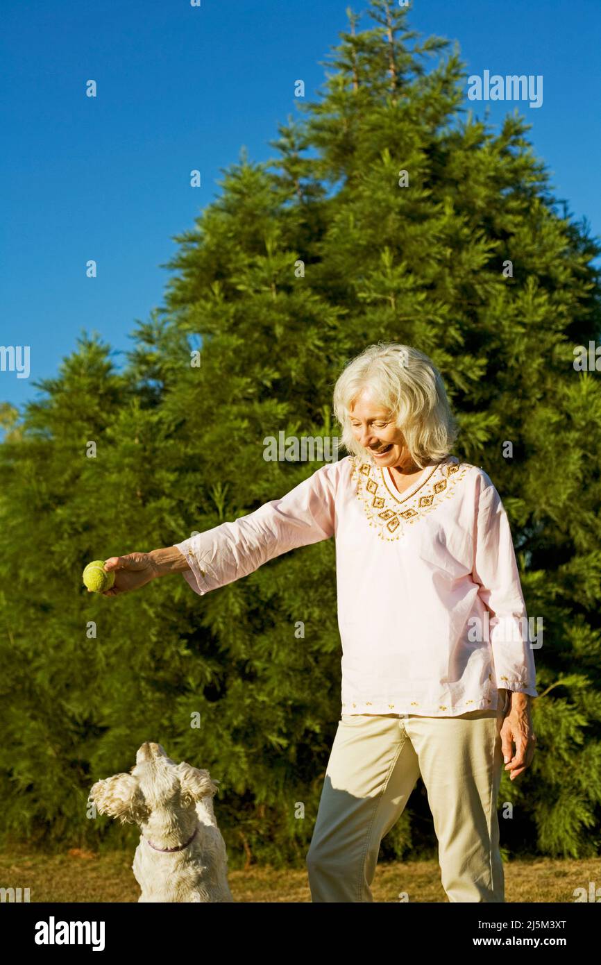 senior woman with her elderly Cockapoo dog Stock Photo