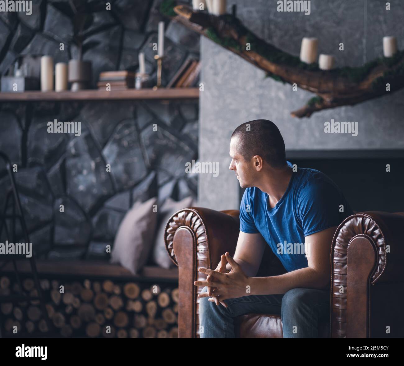 Adult man in blue t-shirt at home Stock Photo