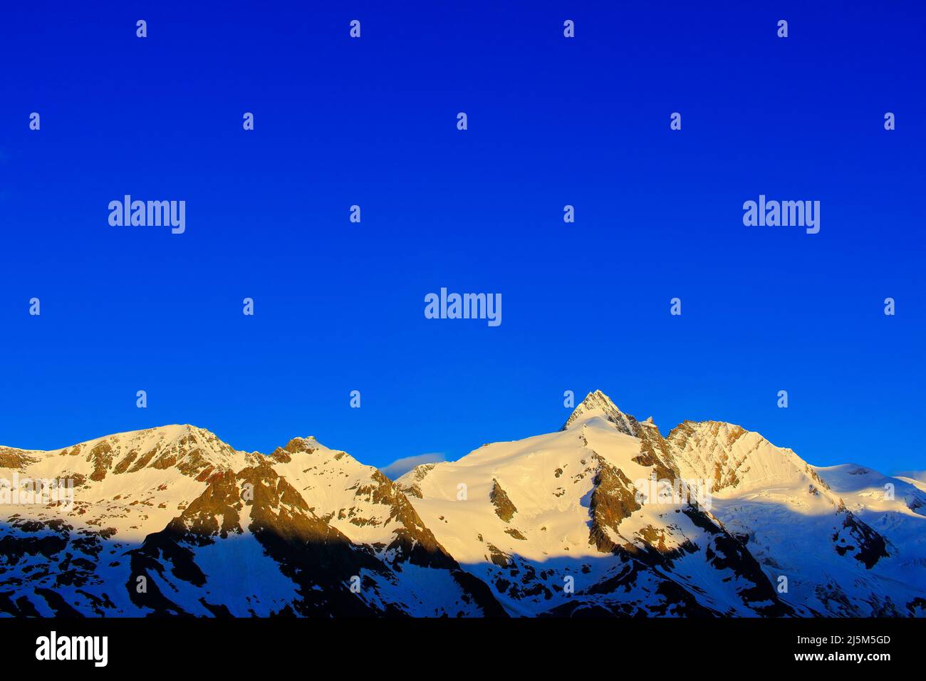 Morning light mountains with blue sky without clouds. Mountains in the Alps. Mountain scenery in winter. Grossglockner ountain in Hohe Tauern, Austria Stock Photo