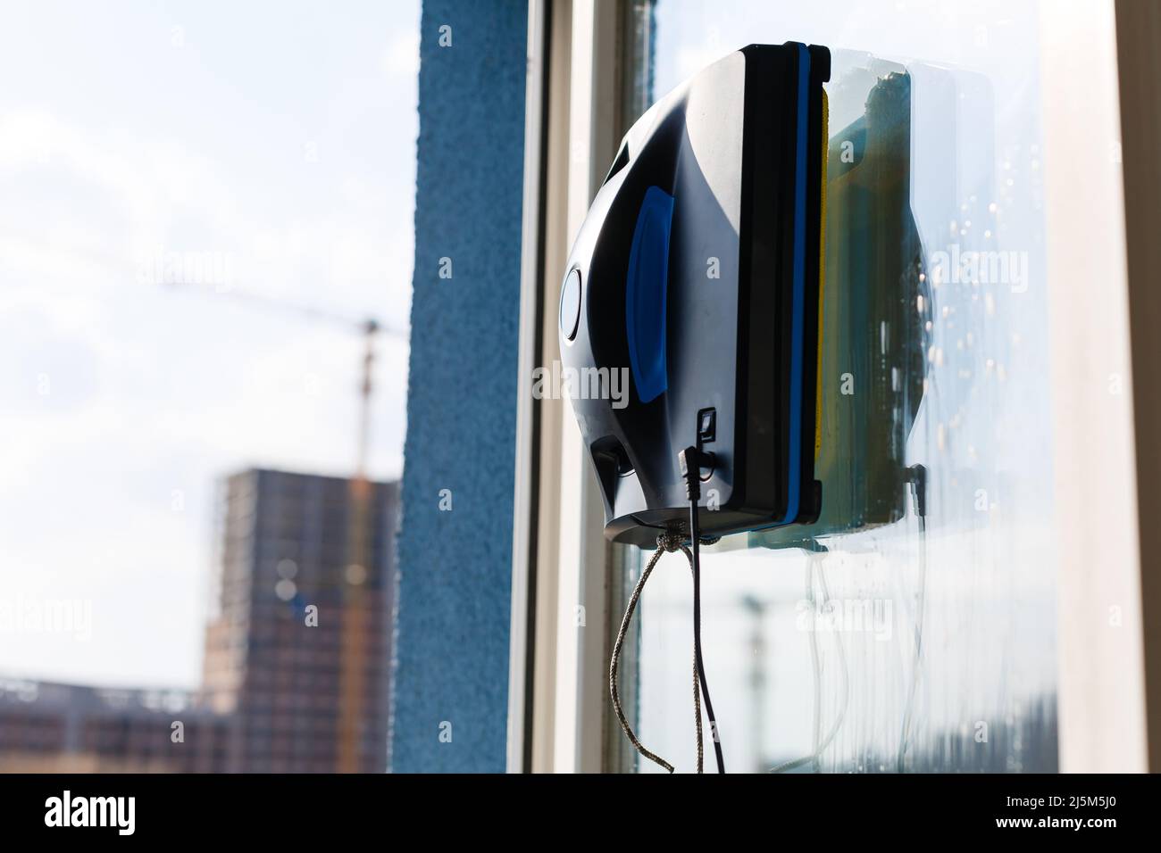Robot window cleaner work on dirty window. Cleaning the house with
