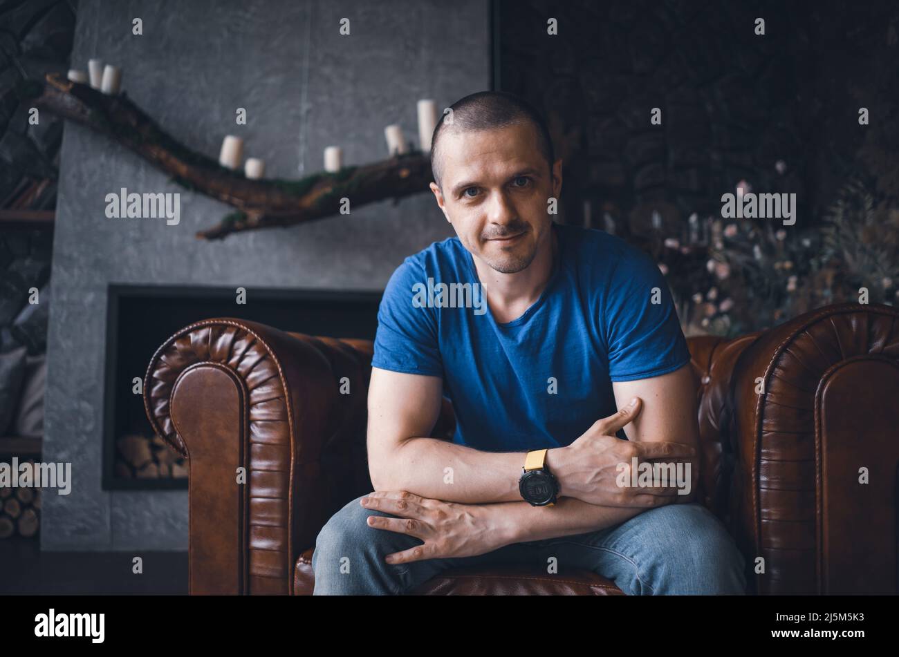 Adult man in blue t-shirt at home Stock Photo