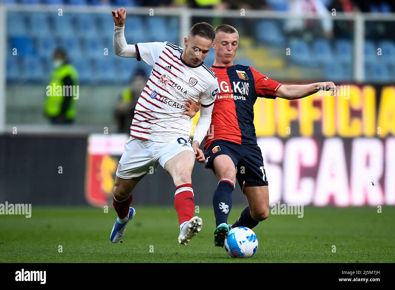 Genoa, Italy. 24 April 2022. Albert Guomundsson of Genoa CFC competes for  the ball with Marko Rog of Cagliari Calcio during the Serie A football  match between Genoa CFC and Cagliari Calcio.