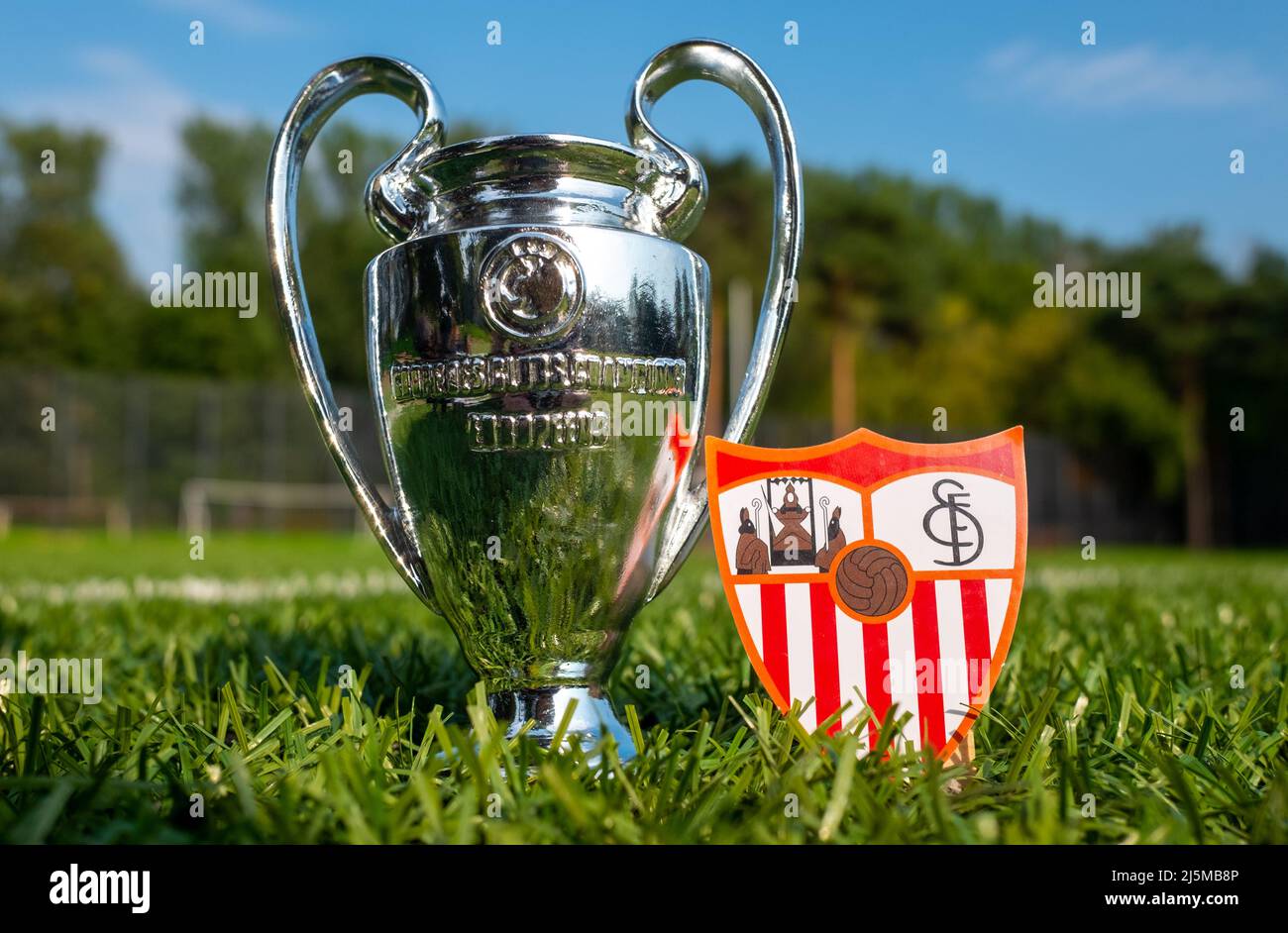 August 30, 2021, Seville, Spain. The Sevilla FC emblem and the UEFA Champions League Cup on the green turf of the stadium. Stock Photo