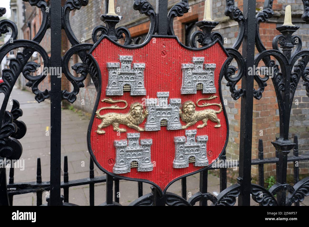 Winchester coat of arms, with Gules five Castles triple towered in saltire Argent masoned proper the Portcullis part-raised. Abbey Garden gate. UK Stock Photo