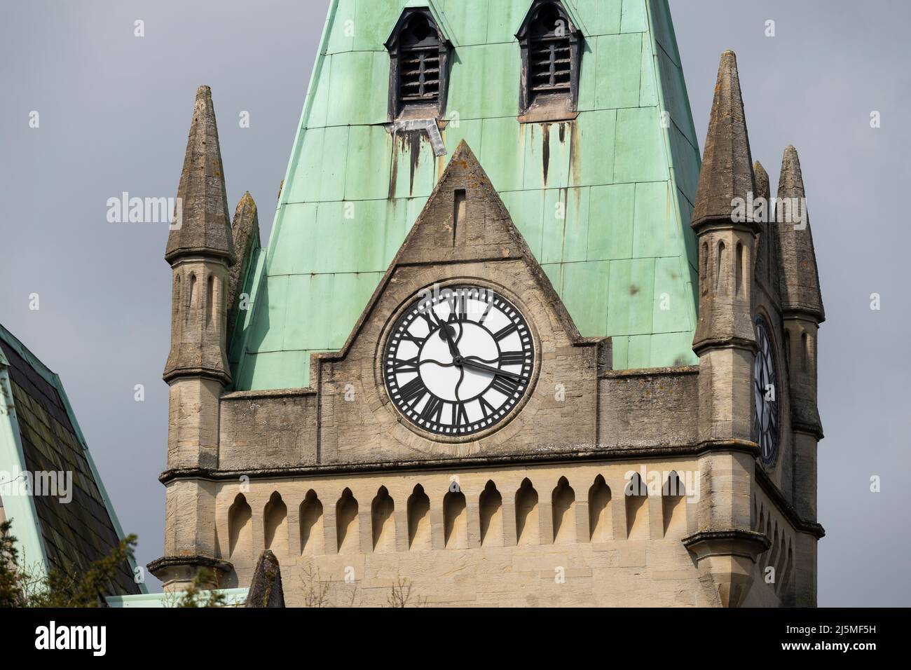 Closeup on the magnificent sandstone and copper sheet clad clock tower of the gothic revival style Victorian Grade II listed Guildhall Winchester. UK Stock Photo
