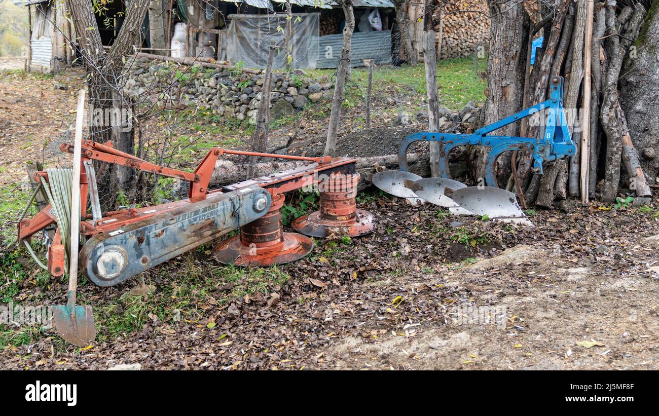 Agricultural machinery and equipment laying on the ground in a farm, Artvin, Turkey Stock Photo