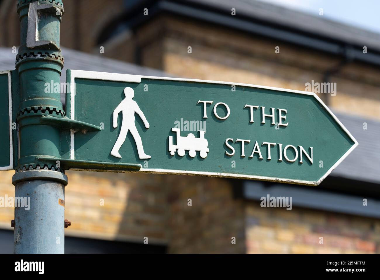 A street sign with the words 'To The Station' giving directions for pedestrians to Alresford train station on the Watercress Line. Hampshire, England Stock Photo