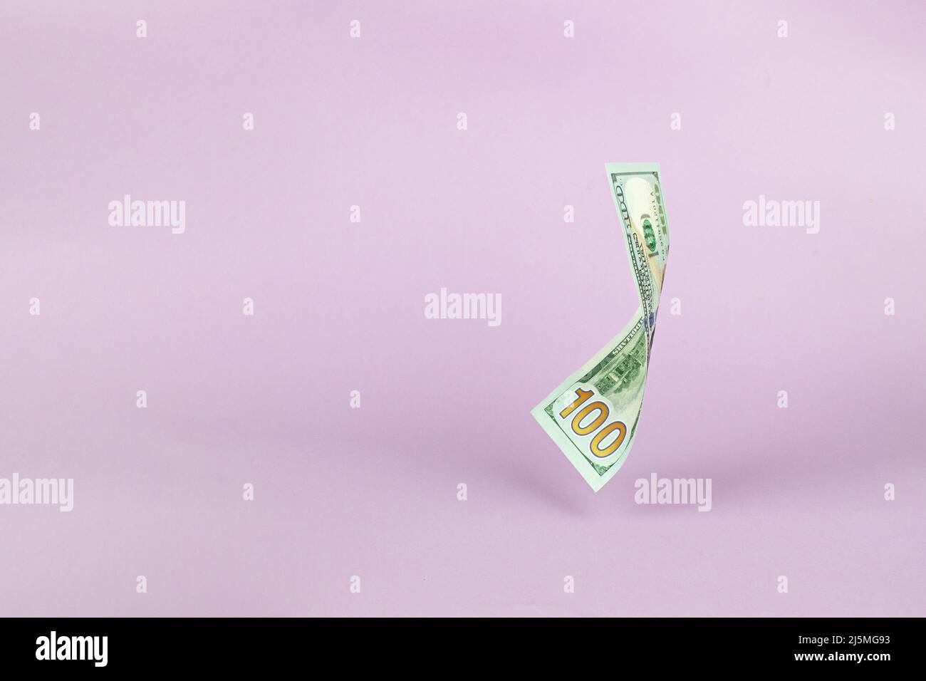 Flying of US dollar banknote on pink pastel background. Investment and ...