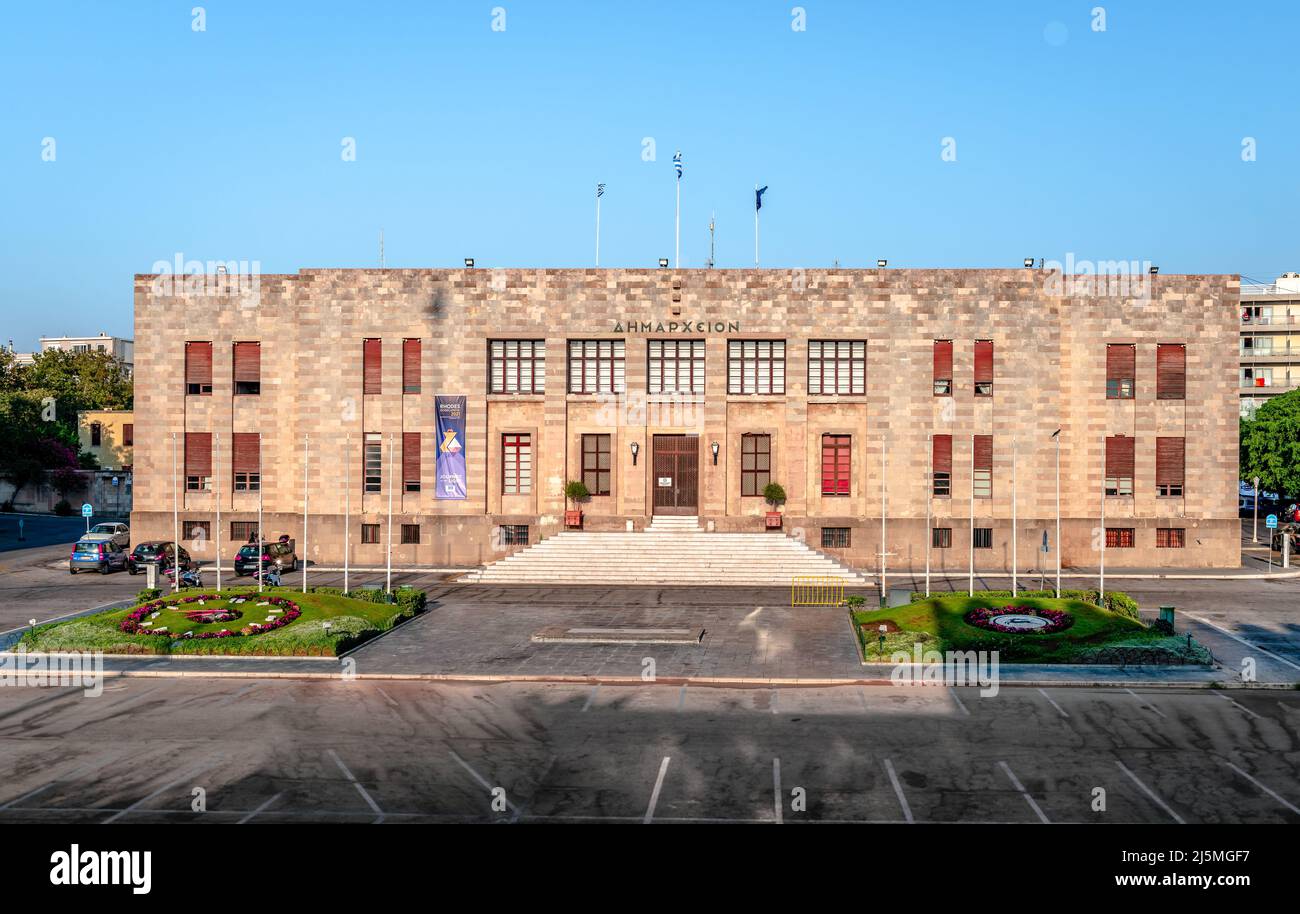 Rhodes, Greece - August 20 2016: Panorama of the Rhodes Town Hall, an old and impressive Italian building situated opposite Mandraki Harbour. Stock Photo