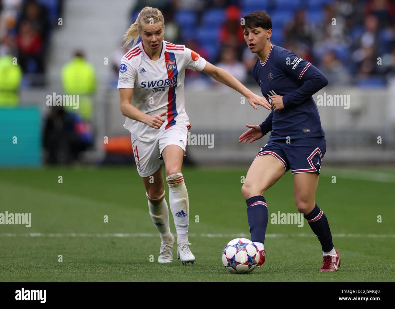 Lyon, France, 24th April 2022. Elisa De Almeida of PSG lays the ball off as  Ada Hegerberg of Lyon closes in during the UEFA Womens Champions League  match at OL Stadium, Lyon.