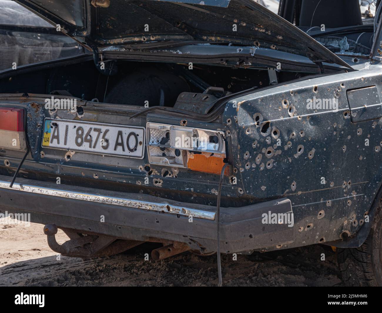 Bucha, Ukraine - April 2022: Cars of civilians shot by the Russian army. Car after being shot with machine guns. Car after shelling from a machine gun and cut by fragments from mines. Stock Photo