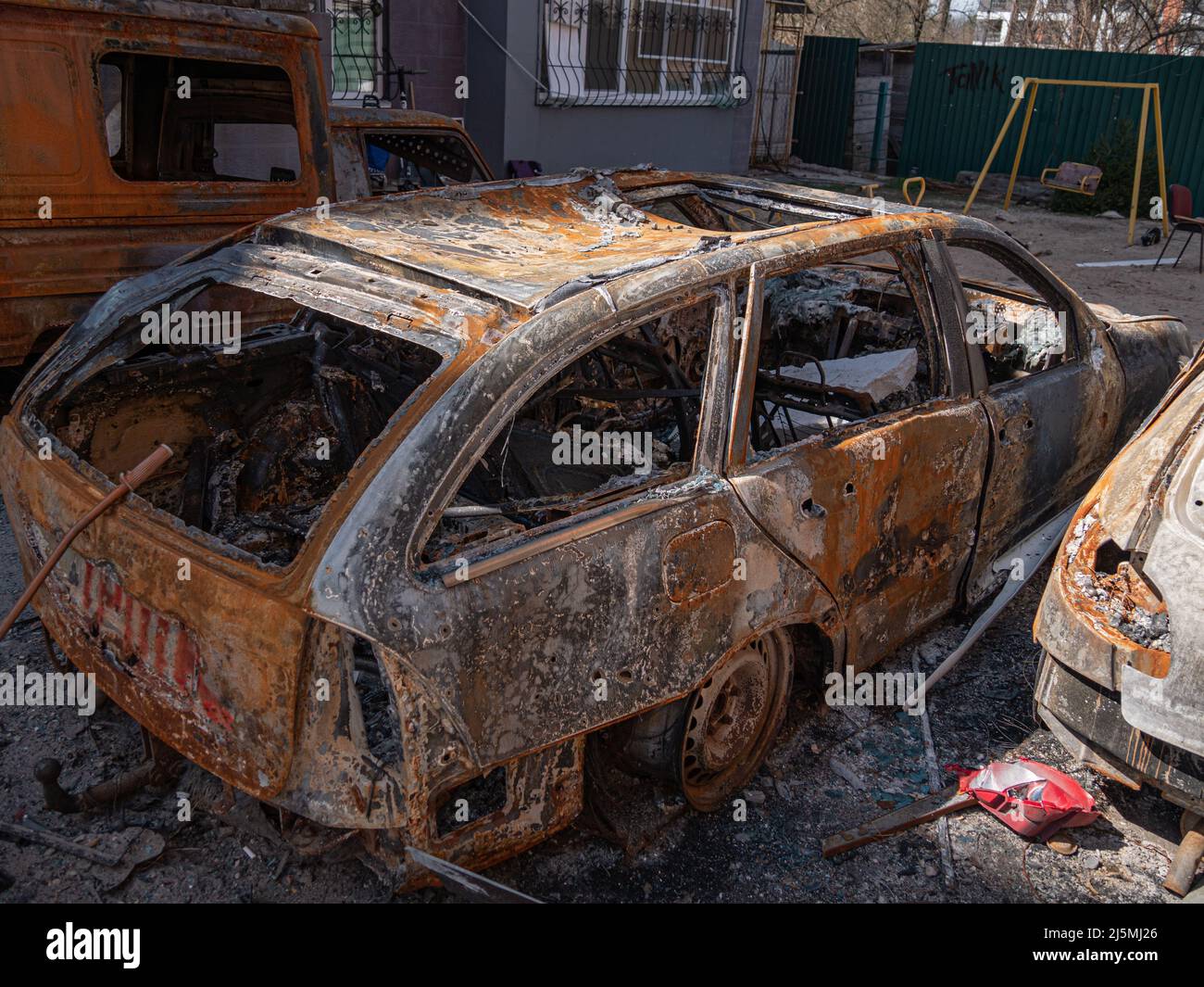 Irpin, Ukraine - April 2022: Burned cars as a result of the bombing of Irpin. Russian military aggression against Ukraine. Missile strike on residential district. Burnt cars on city streets Stock Photo