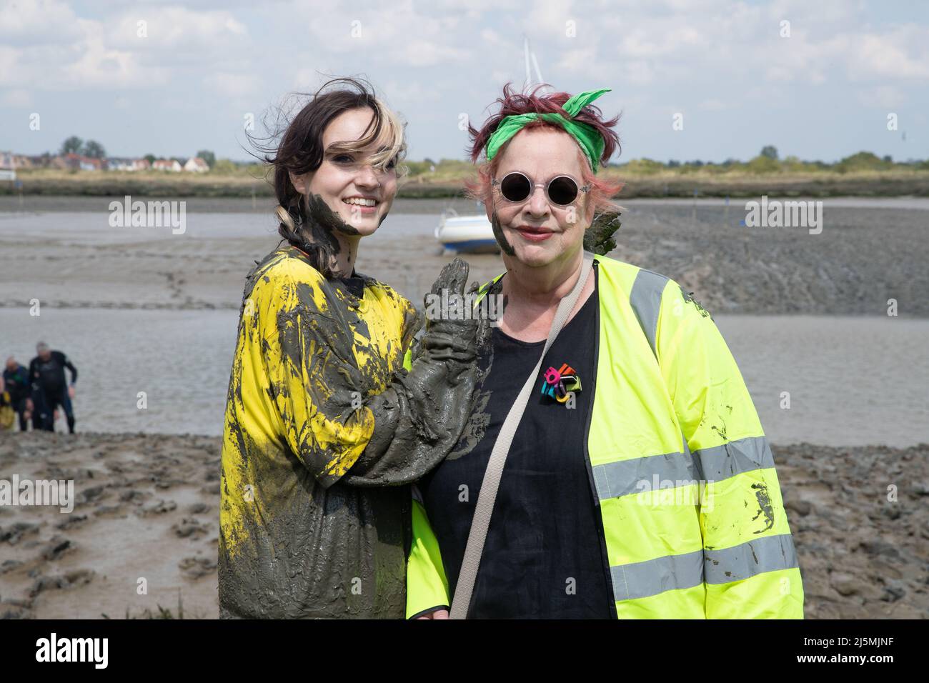 Jo Brand and her daughter Maisi take part in the Maldon Mud Race in Maldon, Essex as the race returns for the first time in two years. The Maldon Mud Race is an annual fun race held in spring (originally in the winter, now in late April or early May) at Promenade Park in Maldon, Essex, England, in which entrants compete to complete a 500 metres (550 yd) dash, in thick mud, over the bed of the River Blackwater. The race is organised by the Lions & Rotary clubs of Maldon and Maldon District Council which raises money for charity. Stock Photo