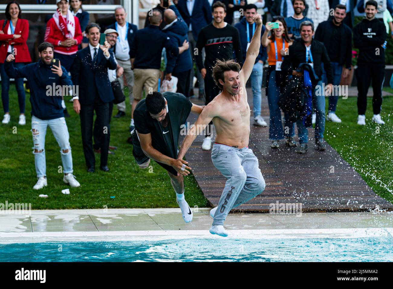 Barcelona, Spain. 24th Apr, 2022. Carlos Alcaraz of Spain jump into the  pool with his trainer Juan Carlos Ferrero of Spain after winning the  Barcelona Open Banc Sabadell tennis match at the