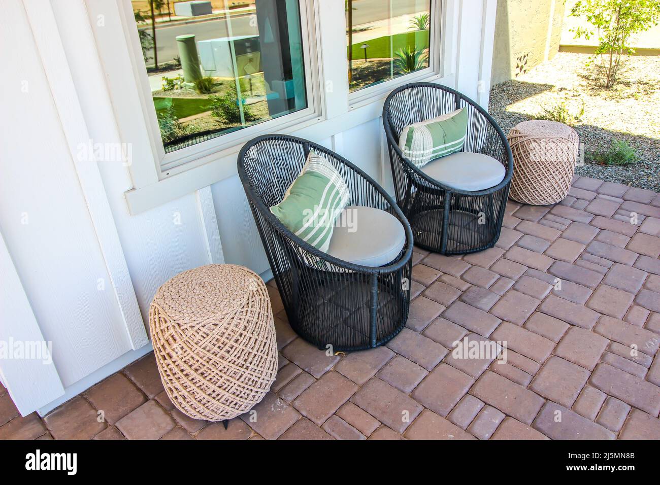 Pavers Front Patio With Two Rattan Chairs Stock Photo - Alamy