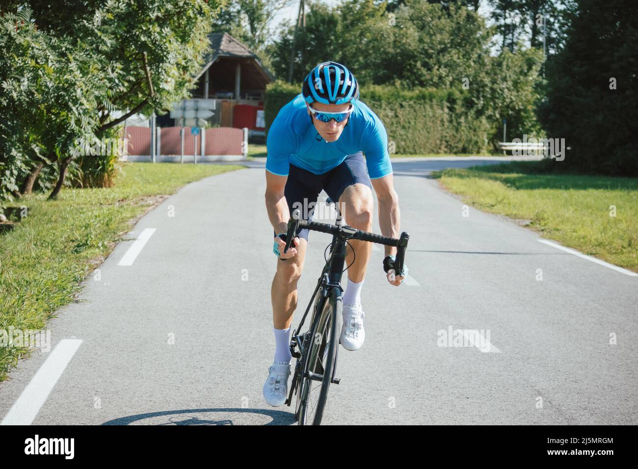 Muscular man, professional racing bicyclist sprint cycling, with
