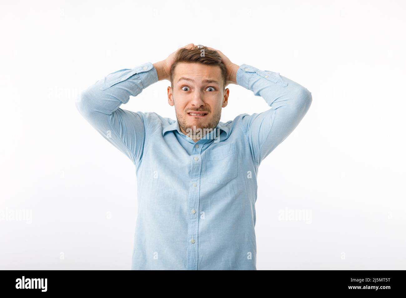 Portrait of a man in a desperate situation. The man is extremely confused and alarmed due to failure. Stock Photo