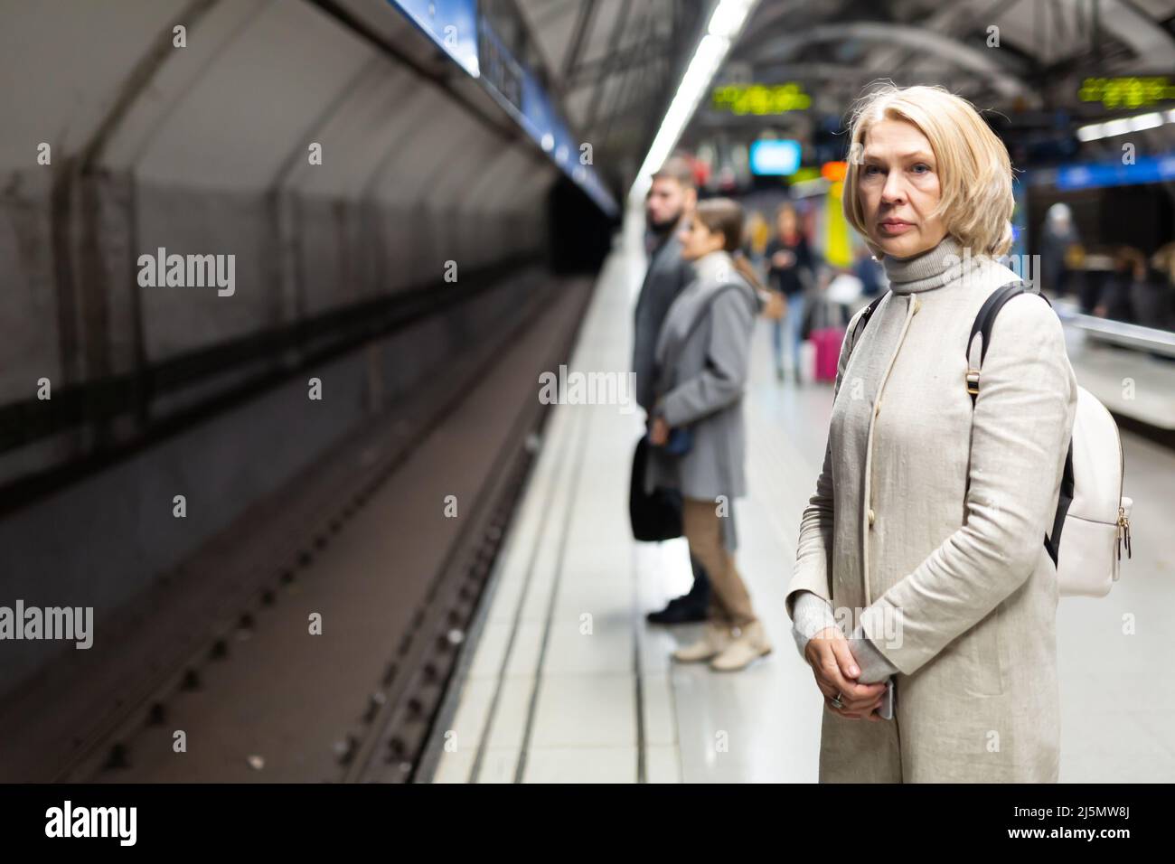 Woman waiting train in subway hi-res stock photography and images - Alamy