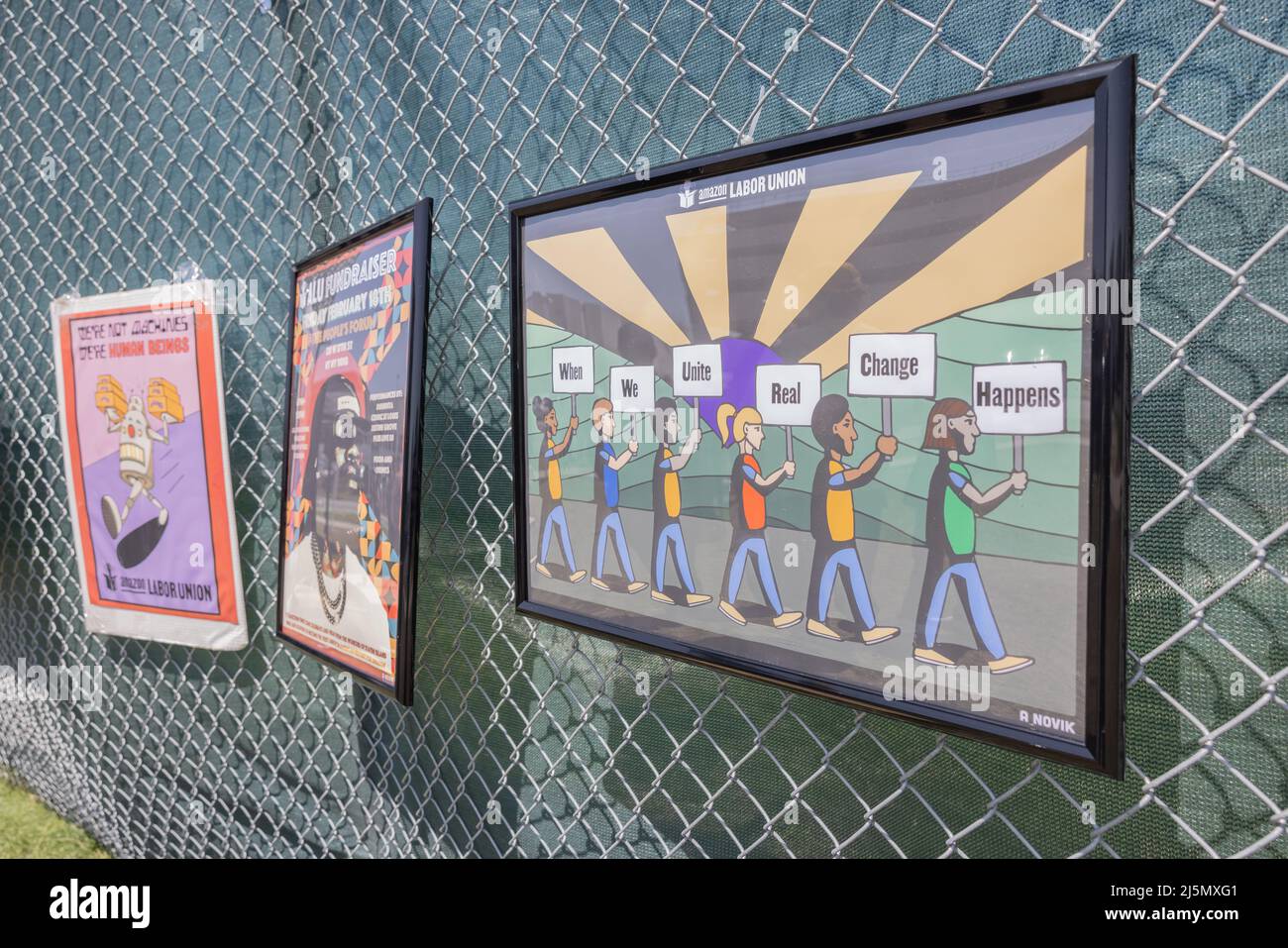 STATEN ISLAND, N.Y. – April 24, 2022: Pictures are seen on a fence at a Staten Island Amazon facility after an Amazon Labor Union rally. Stock Photo