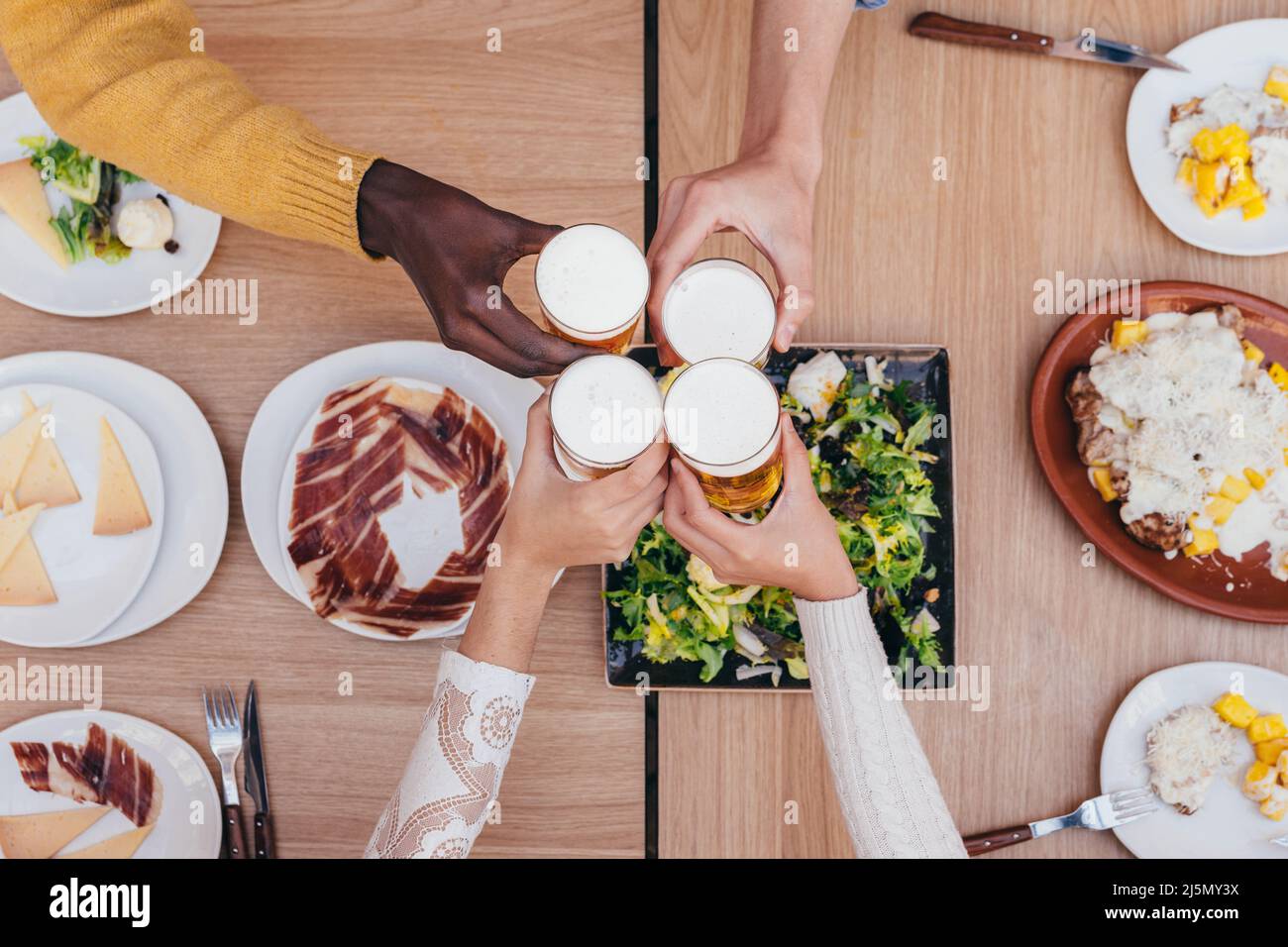 aerial view of a beer toast between 4 friends of different ethnicities Stock Photo