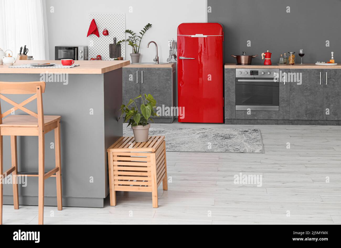 Interior of modern kitchen with red fridge, counters and pegboard Stock ...